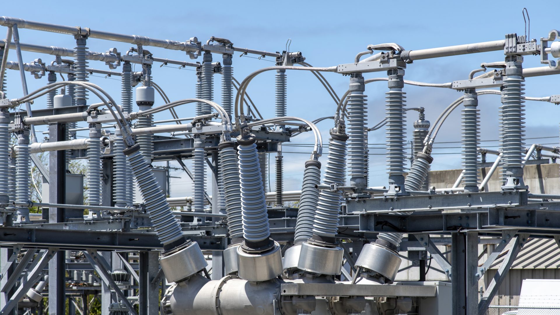 High-voltage bushings on a utility transformer at an electrical substation Close up view of some high-voltage bushings on a utility transformer at an electrical substation which allows an electrical conductor to pass safely through a conducting barrier